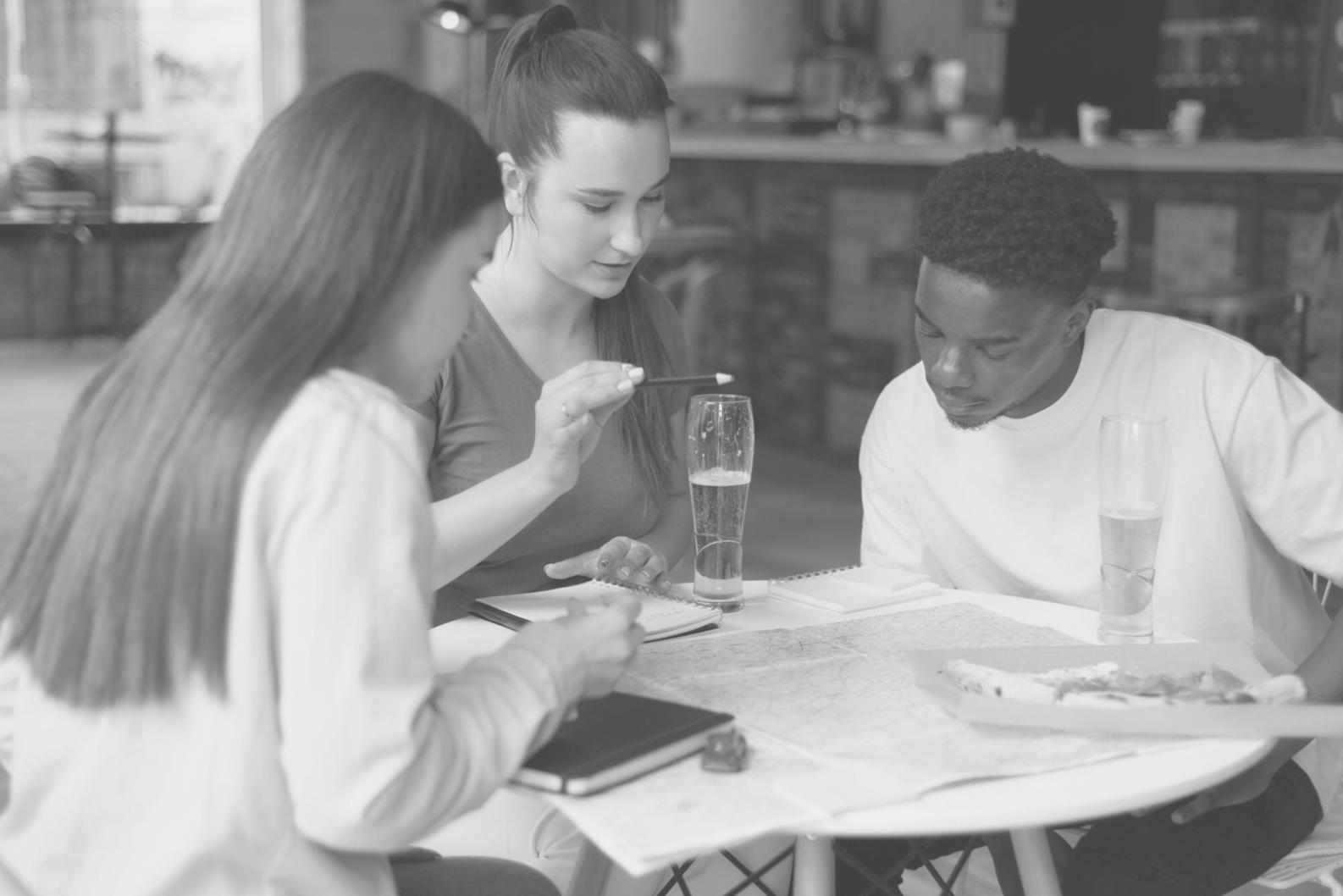 Family reviewing budget documents together at kitchen table
